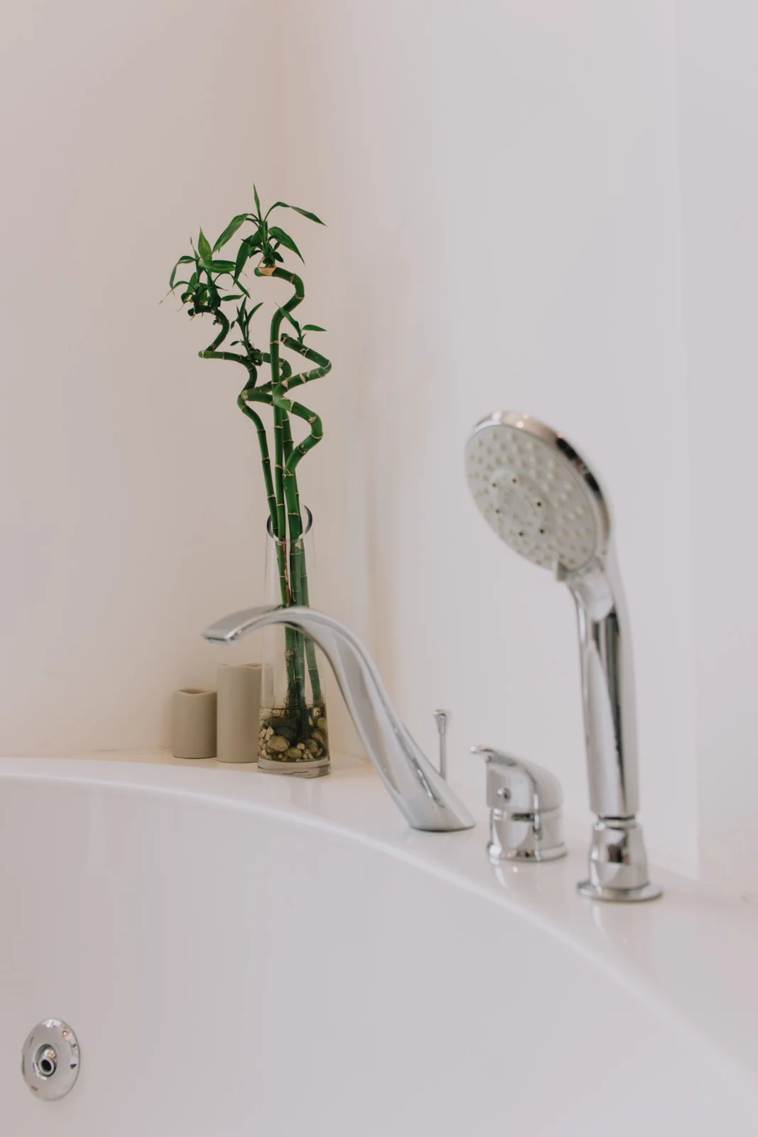 Modern bathroom featuring a bathtub with bamboo decorations and sleek fixtures