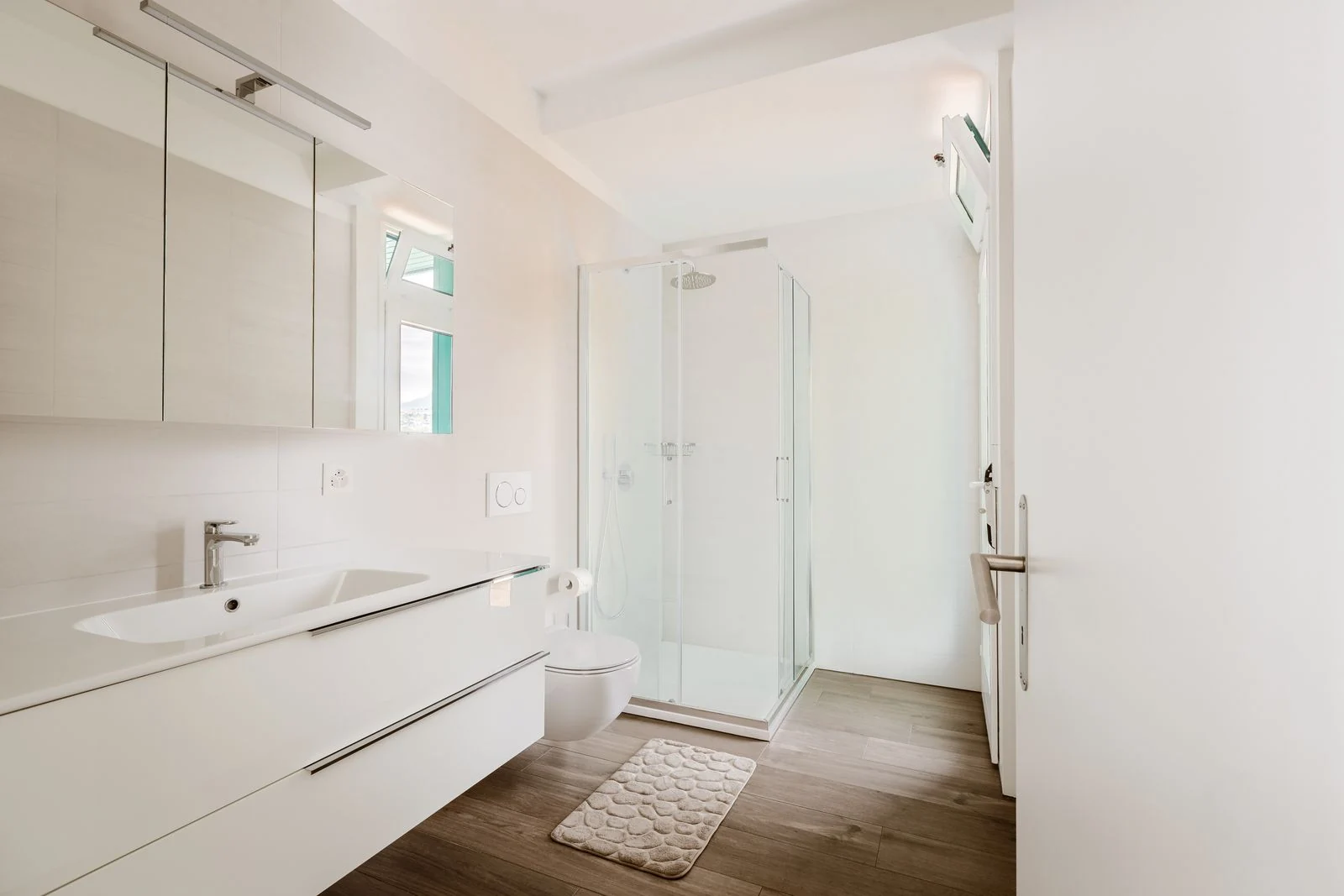 Bright, contemporary bathroom featuring white walls and minimalist design elements