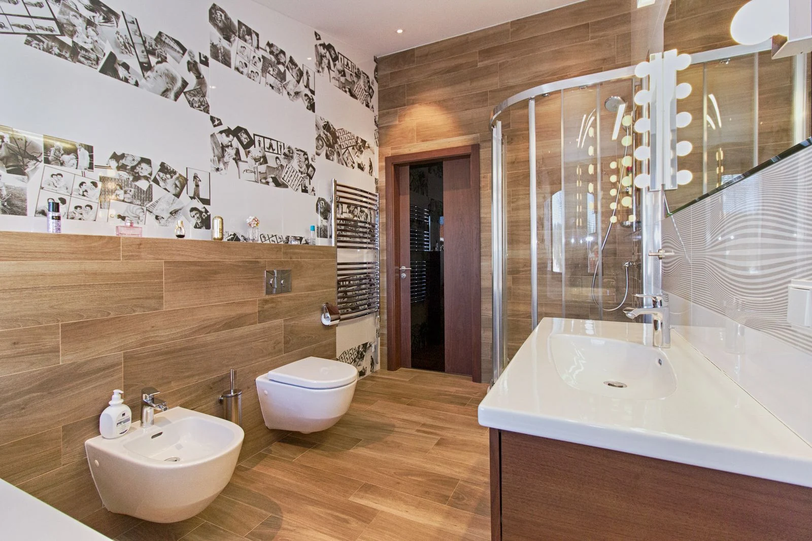 Elegant bathroom featuring wood paneling, modern fixtures, and ample lighting
