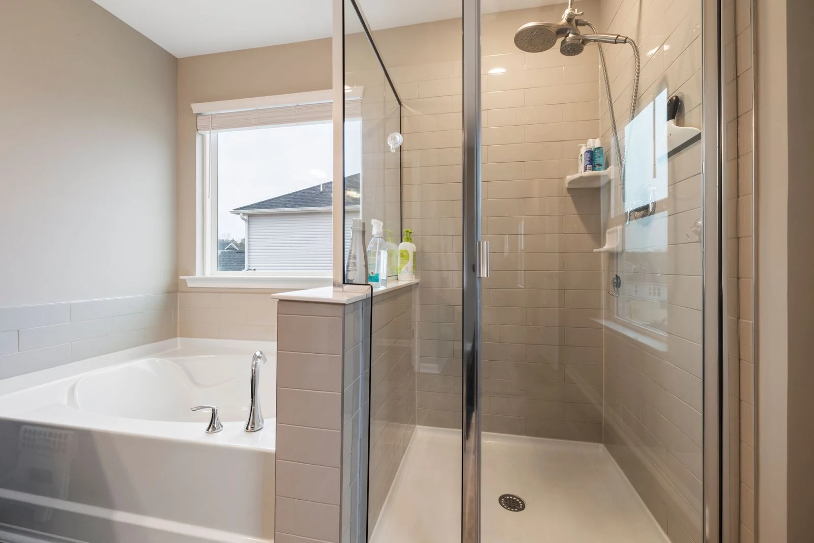 A contemporary bathroom featuring a glass shower and luxurious bathtub for stylish home design