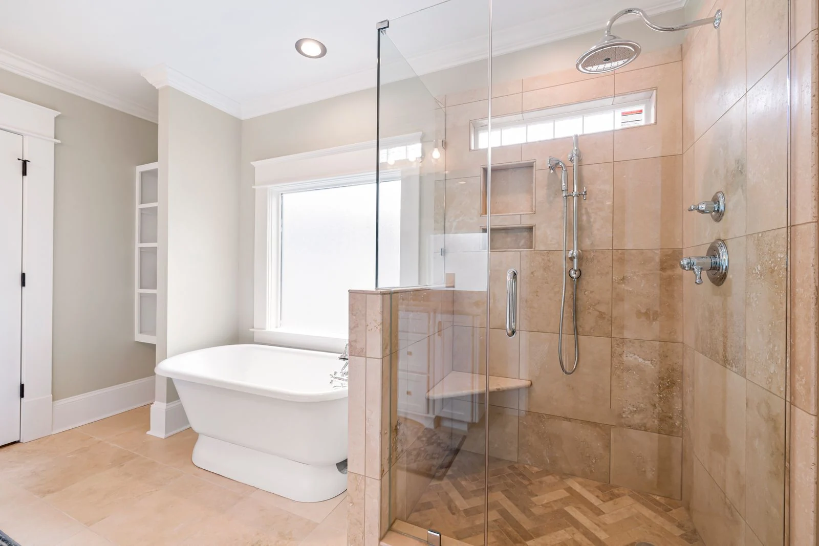 Elegant bathroom with freestanding tub and glass shower enclosure